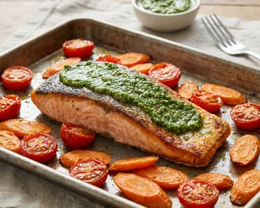 Salmon with oven-baked vegetables and basil pesto
