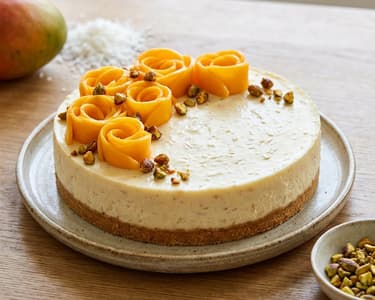 Cheesecake with coconut, mango, and caramelized pistachios