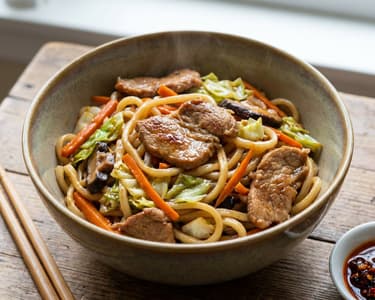 Pork with rice noodles and wok vegetables