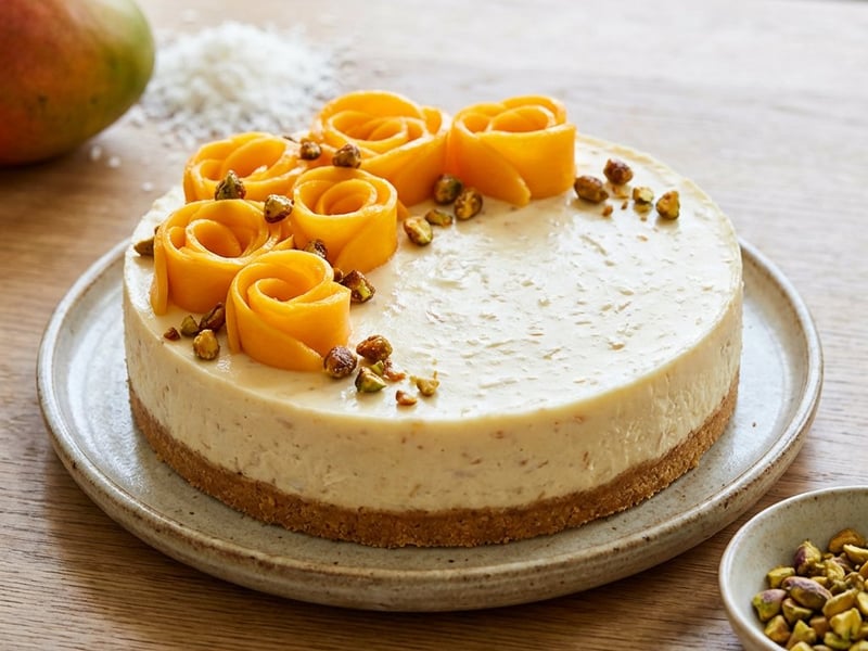 Cheesecake with coconut, mango, and caramelized pistachios